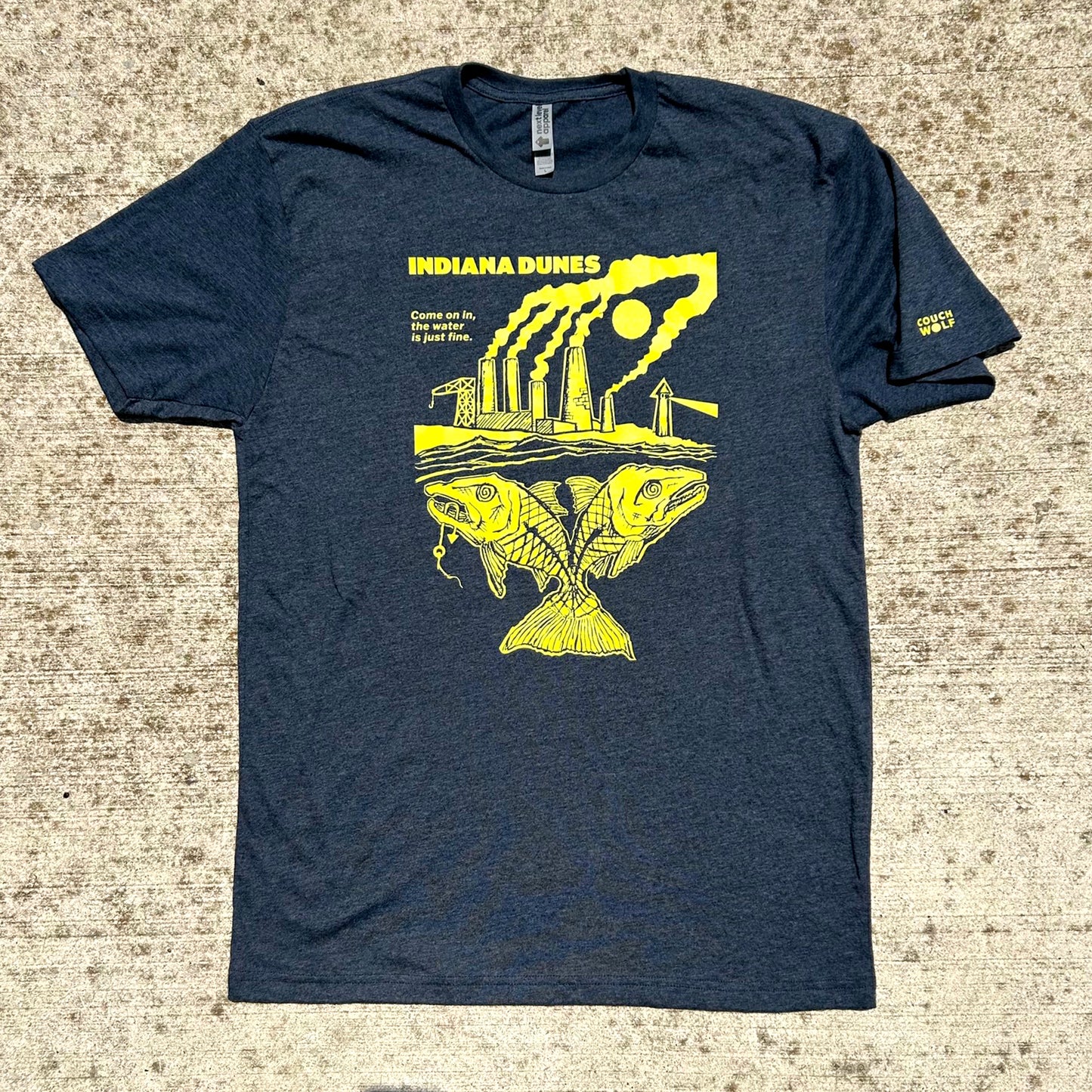 Navy blue t-shirt with yellow graphic of smoke stacks and 2-Headed fish says indiana dunes on a textured surface