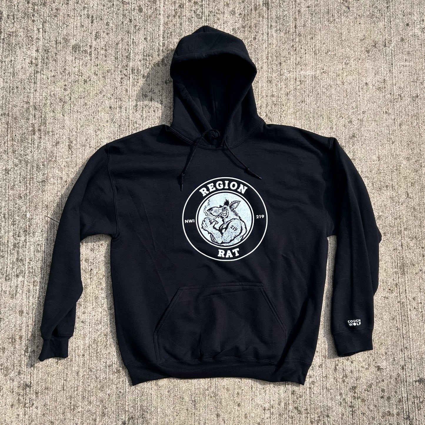 Black hoodie with a white region rat artwork on a textured surface