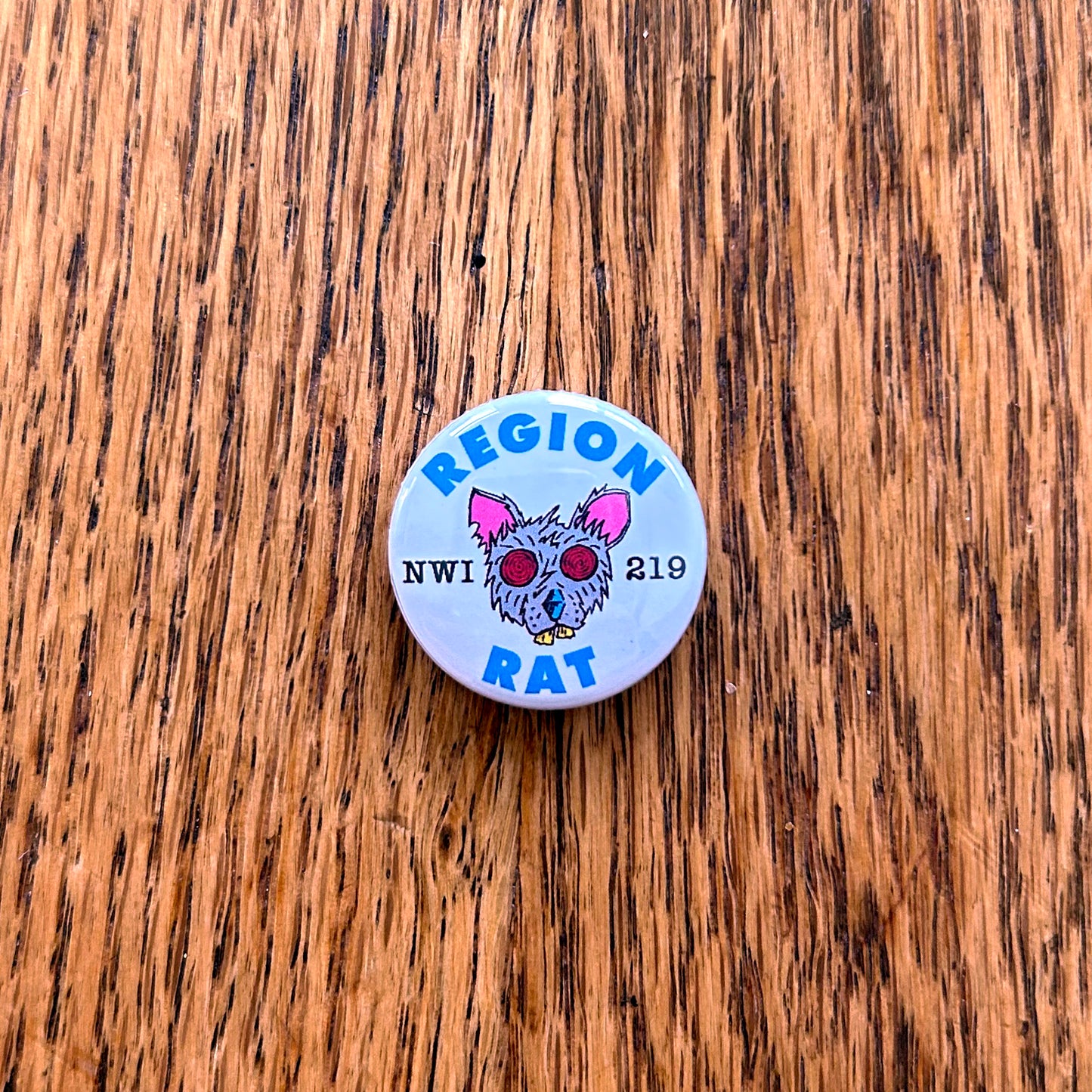 Region Rat Pin shown on wood surface