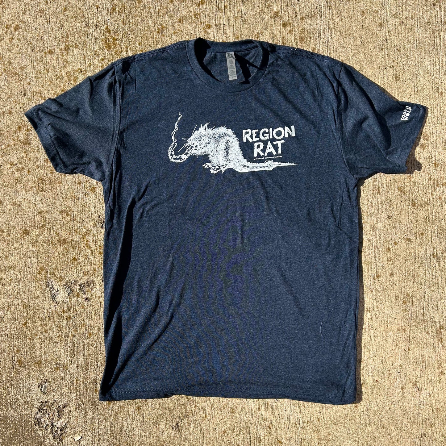 Region Rat shirt navy blue short sleeve shirt with gritty rat smoking cigarette in white ink shirt says Region Rat product of Northwest Indiana, shirt shown on concrete background