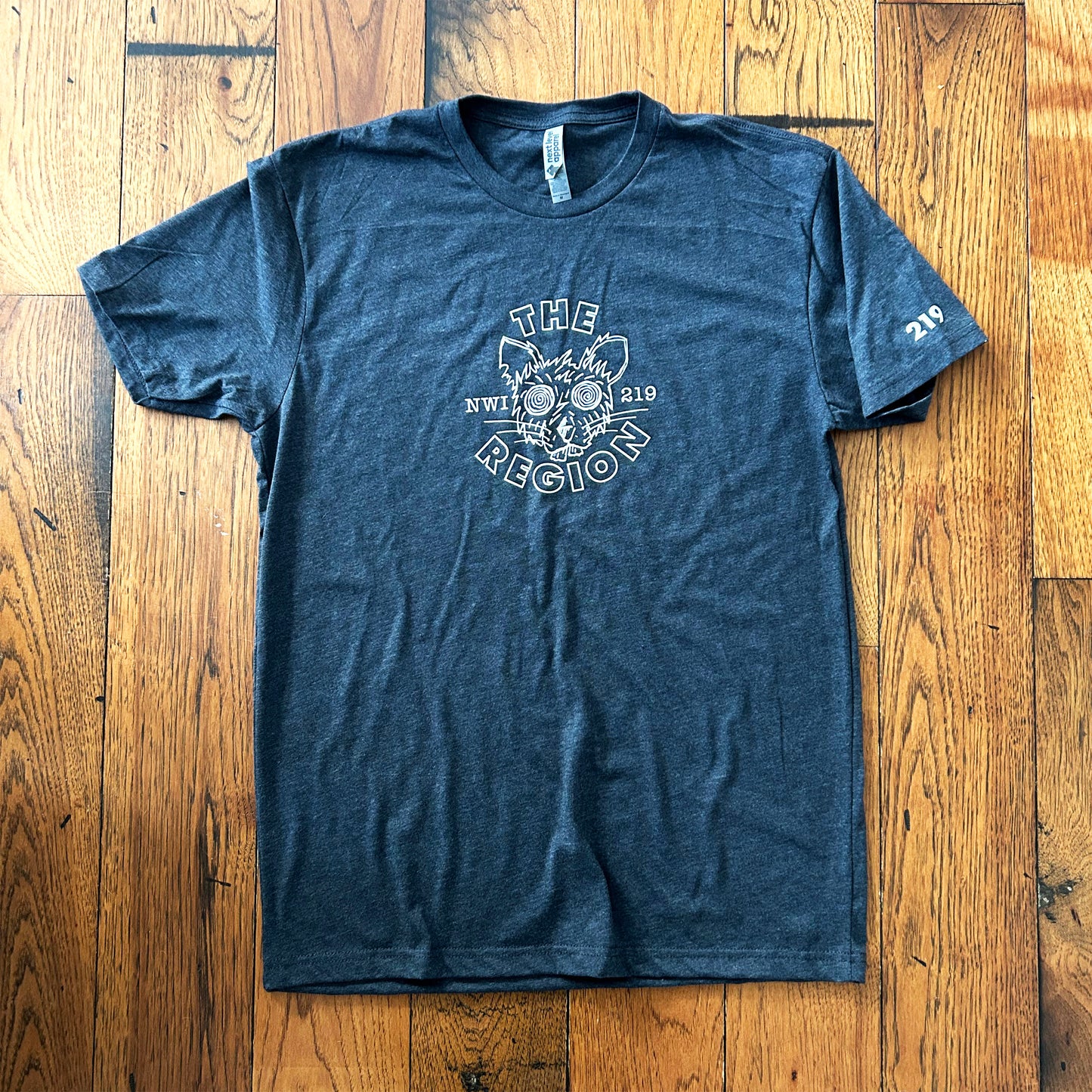 The Region Indiana Region Rat T-Shirt whit ink line art of rat head on charcoal gray t-shirt says "The Region NWI 219"