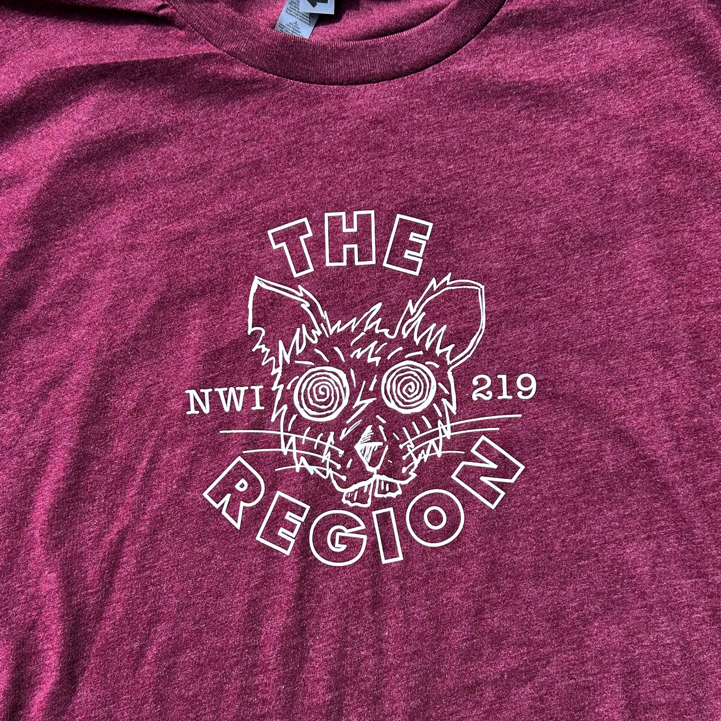 The Region Indiana Region Rat T-Shirt whit ink line art of rat head on burgundy t-shirt says "The Region NWI 219"