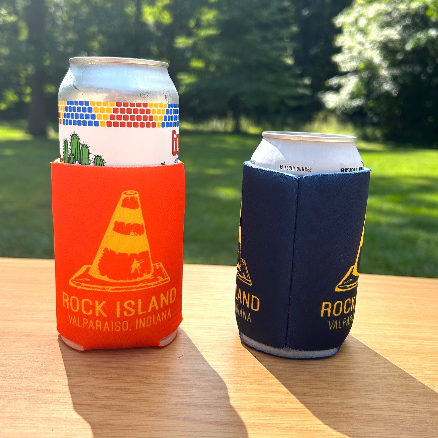 Rock Island Valparaiso Can Cooler several cans in can coolers with road cone artwork that says "Rock Island Valparaiso, Indlana"