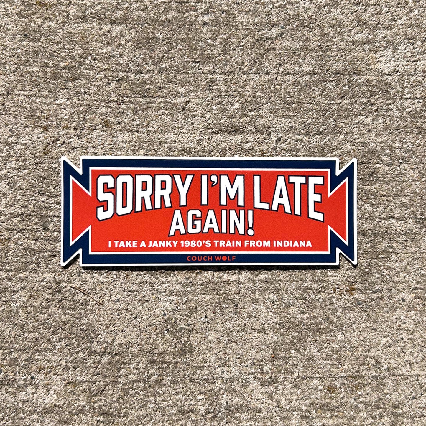 Sticker with text 'Sorry I'm late again! I take a janky 1980's train from Indiana' on a textured surface.