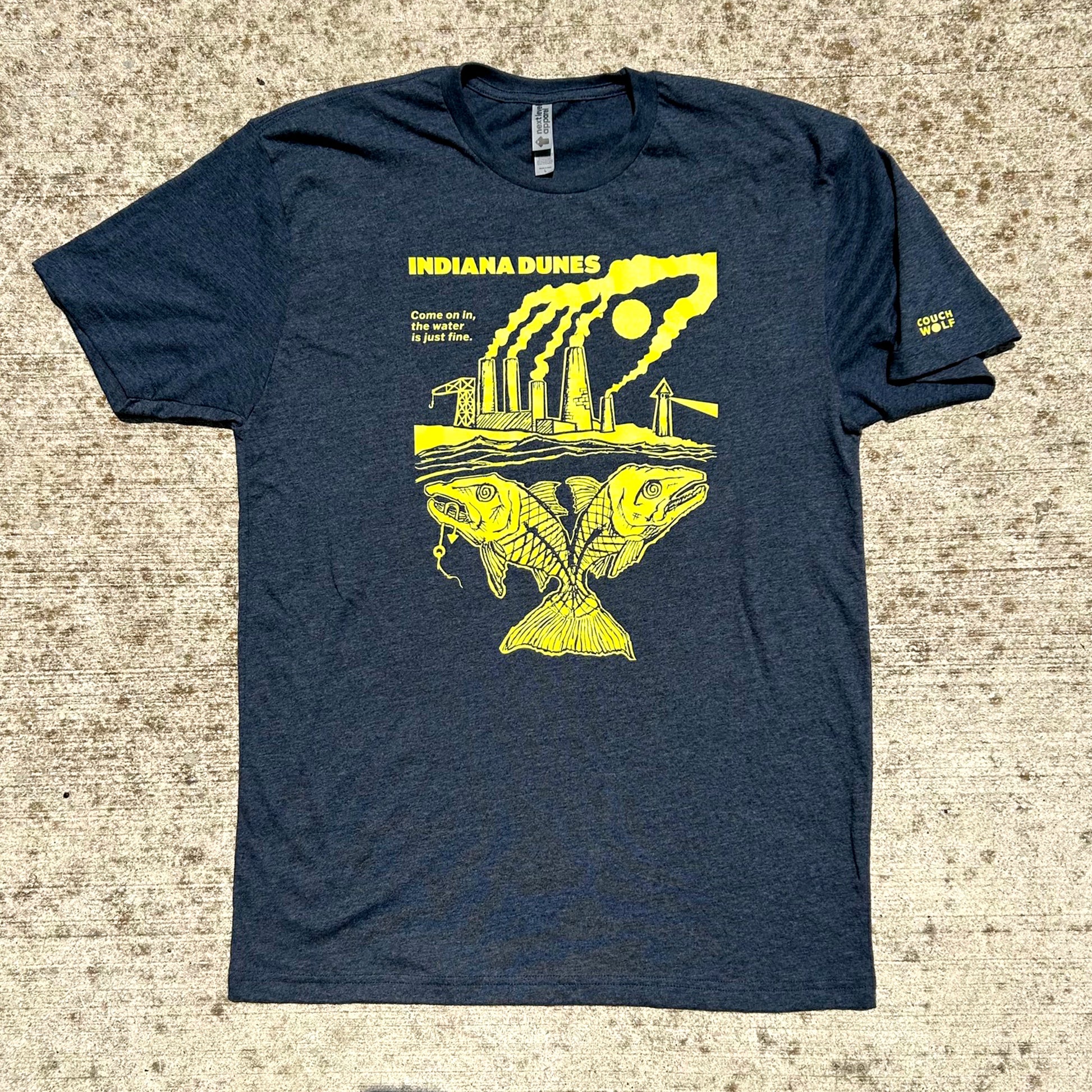 Navy blue t-shirt with yellow graphic of smoke stacks and 2-Headed fish says indiana dunes on a textured surface