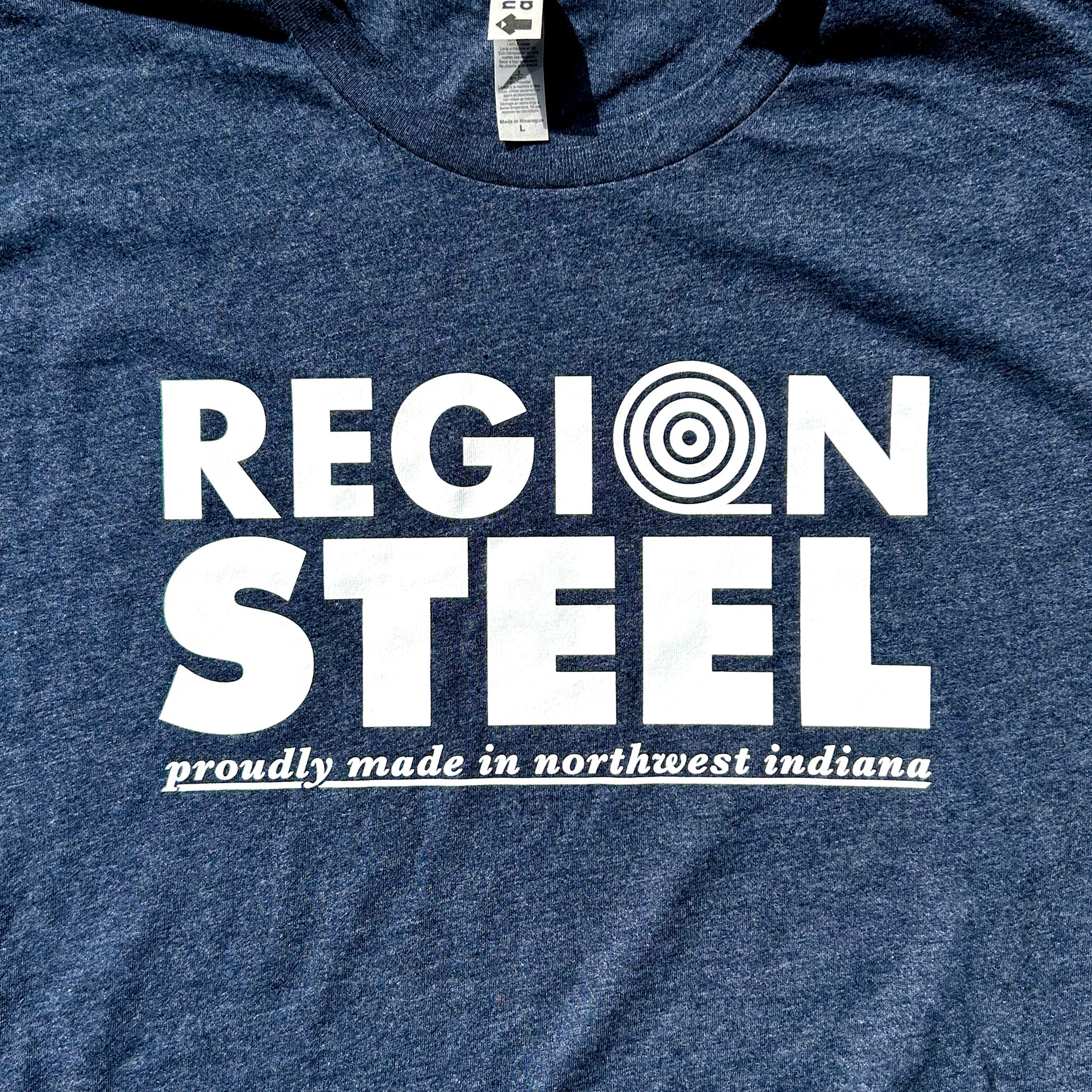 Region Steel Indiana T-shirt navy blue shirt with white bold letters that say "Region Steel proudly made in northwest Indiana close up of shirt chest