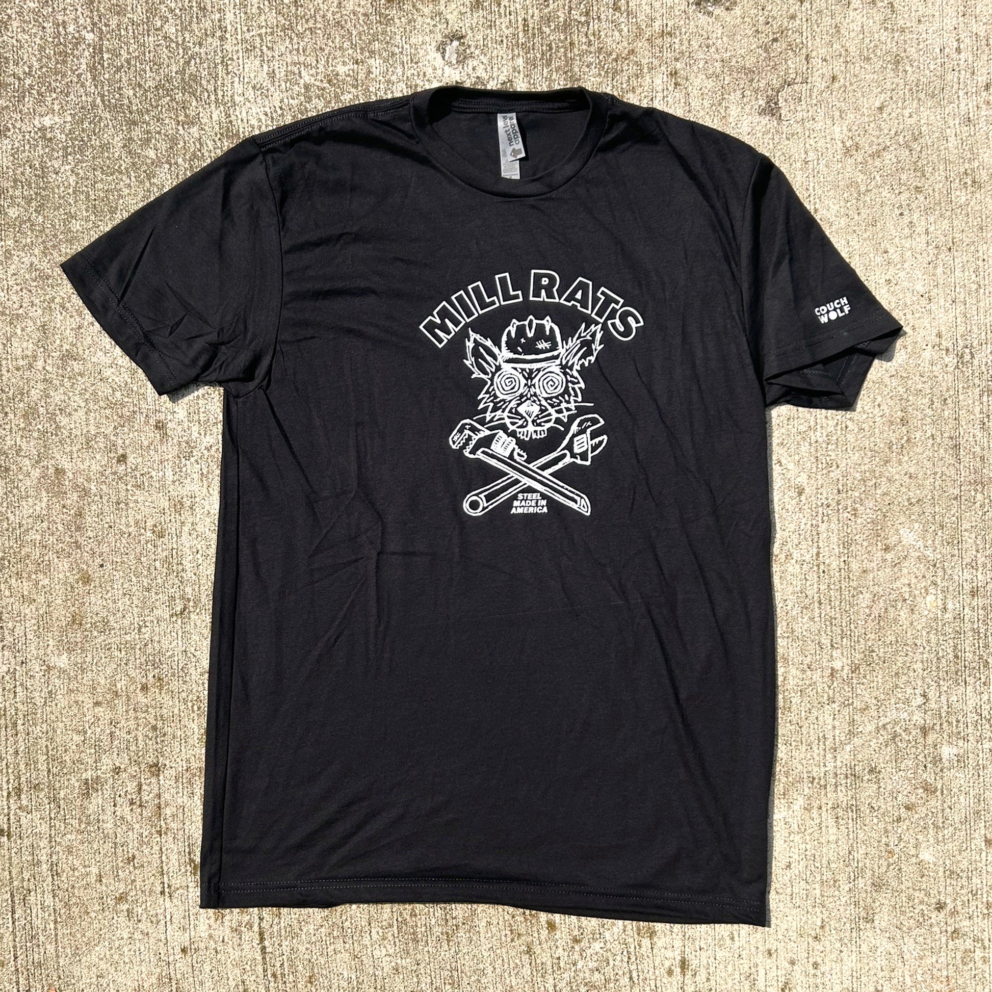 Black t-shirt with white graphic design of rat in helmet says mill rats steel made in americaon a textured beige surface
