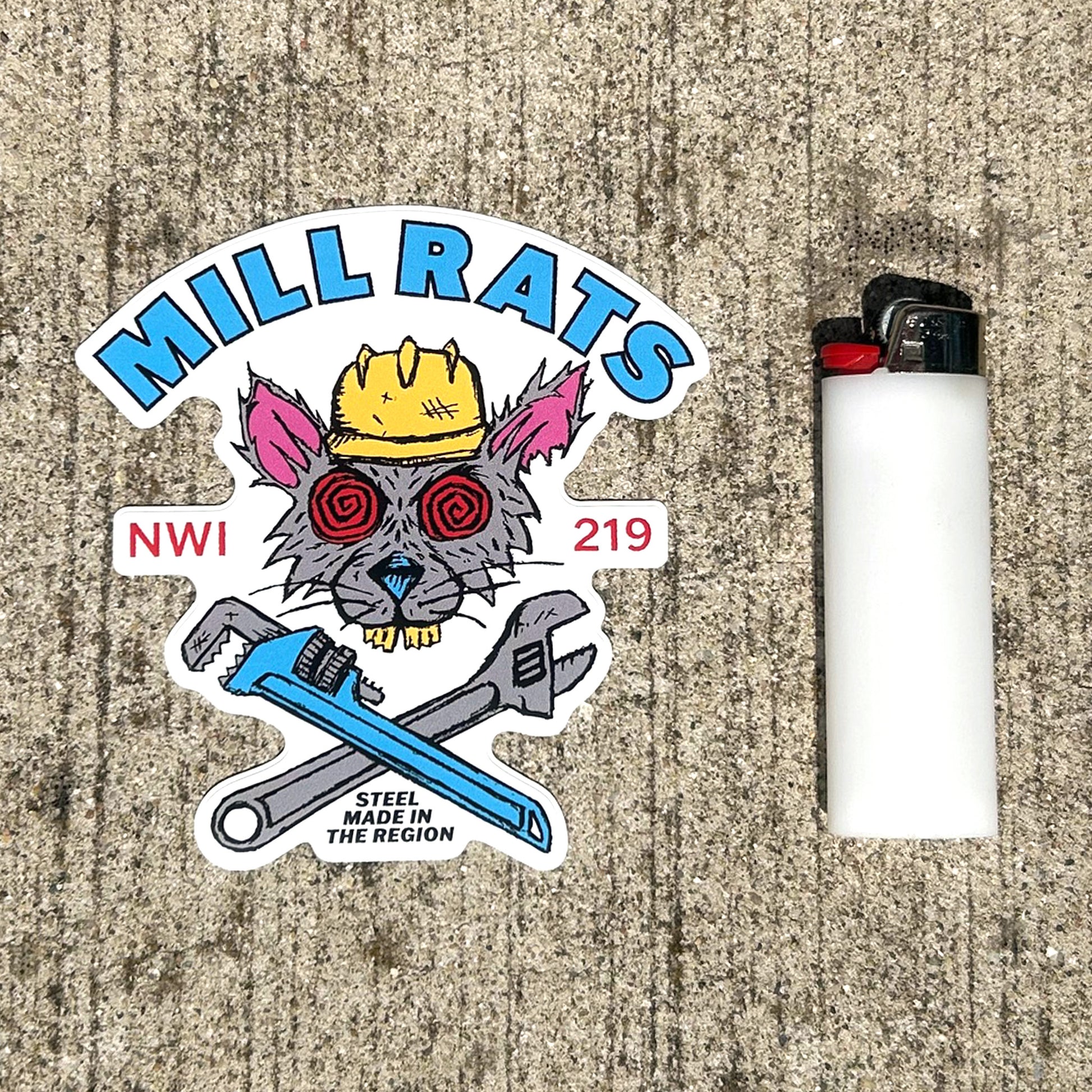 Sticker with 'Mill Rats' design and a lighter on a textured surface
