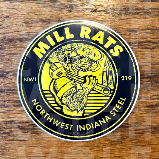 A circular sticker featuring a yellow and black illustration of a rat holding a  wrench, with the text 'MILL RATS NWI 219' and 'NORTHWEST INDIANA STEEL' on a wooden surface.