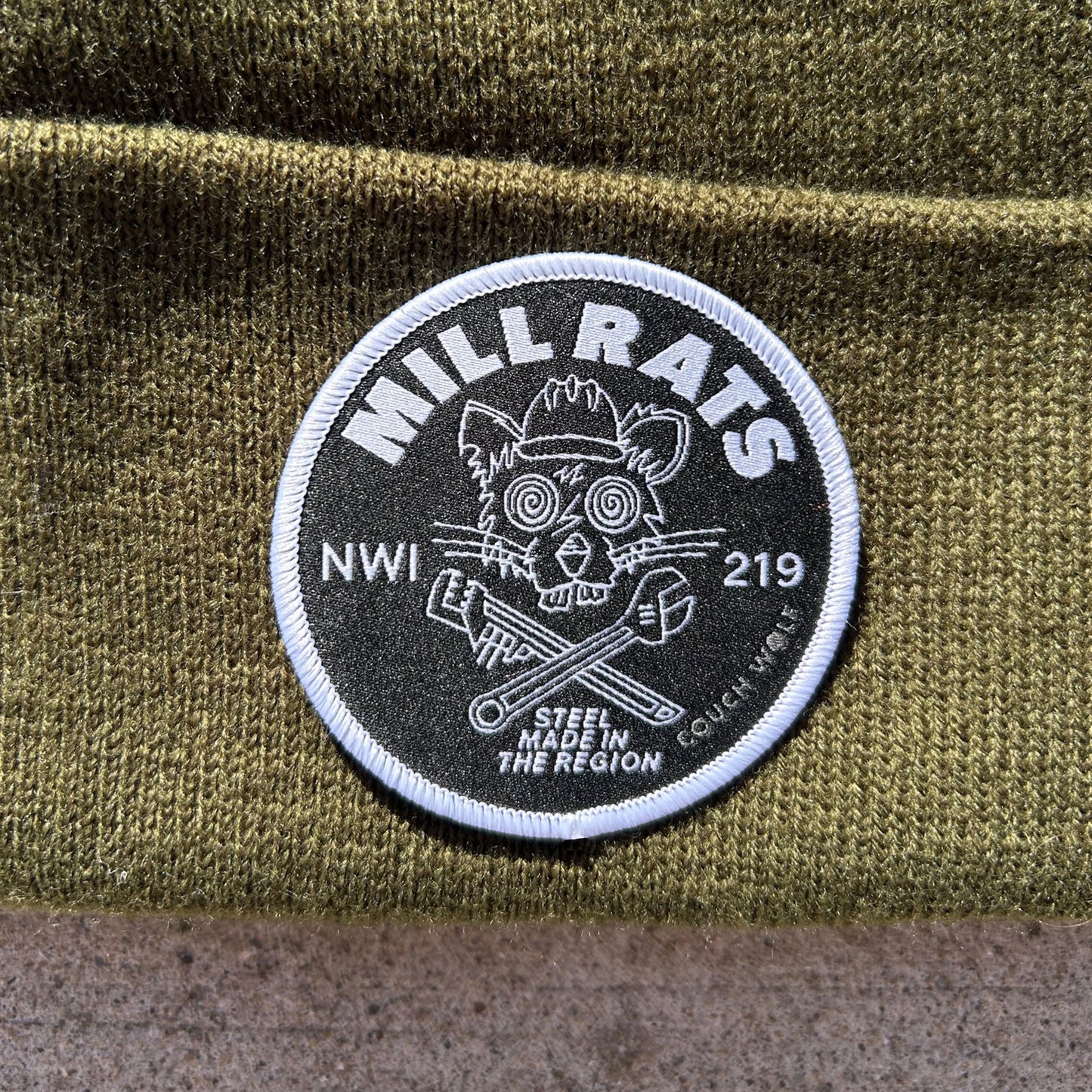 Patch with 'Mill Rats NWI 219' design on a green fabric background