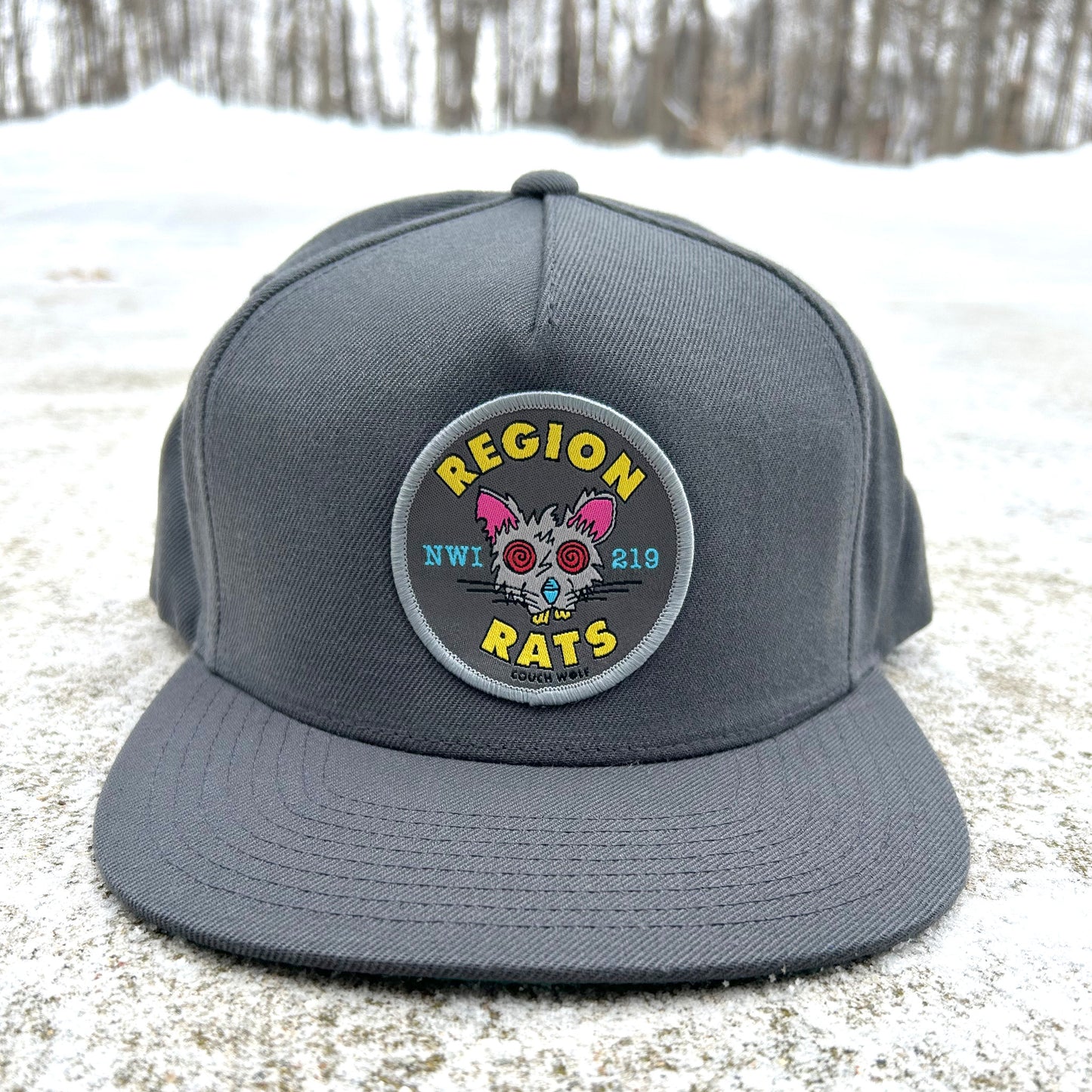 Gray hat with a Region Rat patch on a snowy ground