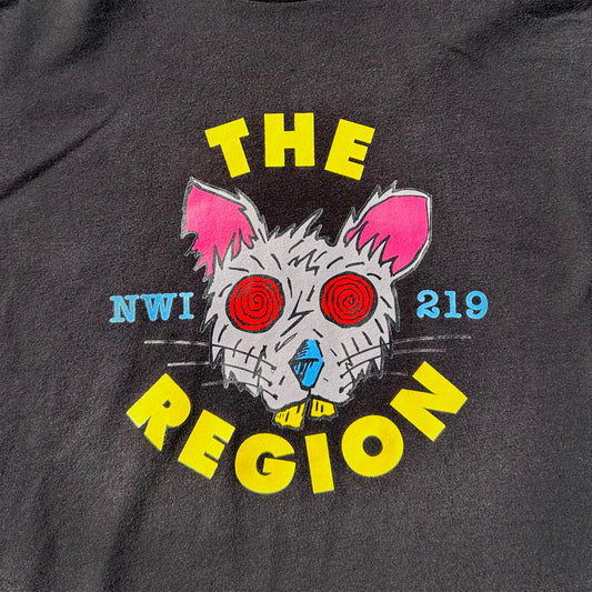 Black t-shirt with a graphic of a Region  Rat's face and text 'THE REGION NWI 219' on a dark background