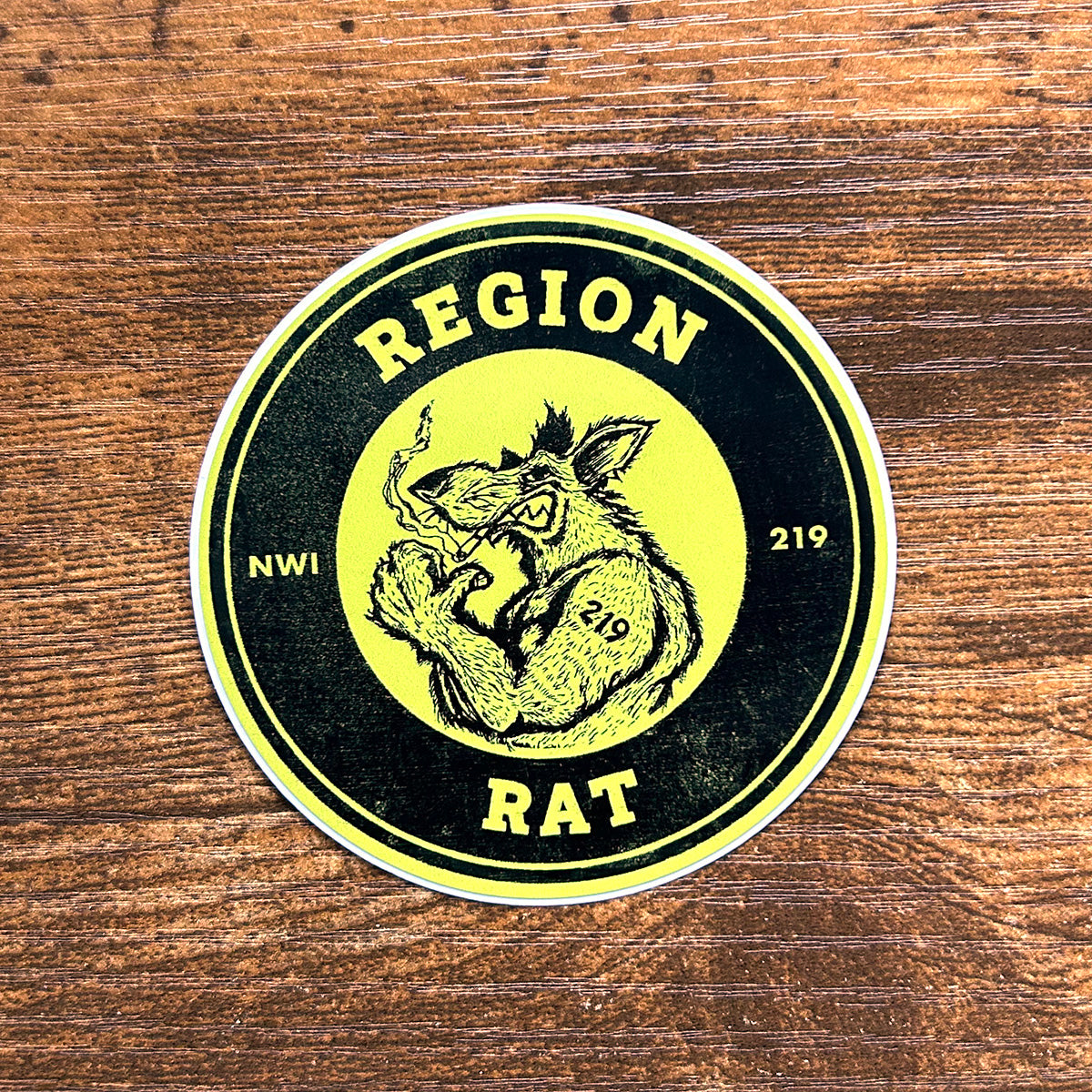 region rat sticker northwest indiana Region Rat sticker the region indiana sticker says "region rat  nwi 219" features flexing buff rat artwork  circle sticker on wood floor background region rat upper body image on sticker