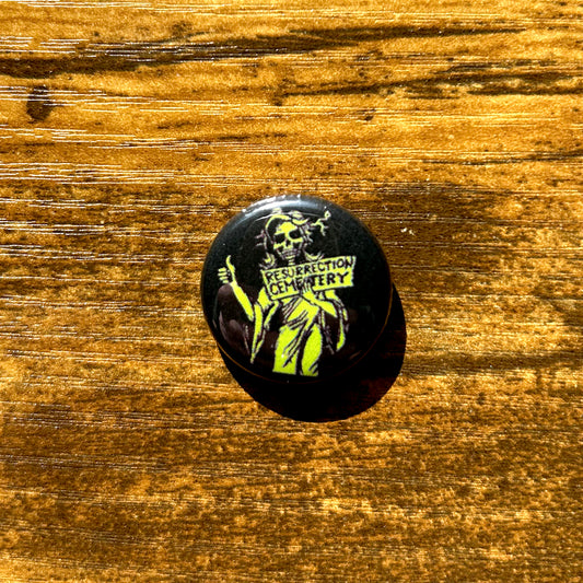 Resurrection Mary  pin round black pin with green ghost art  on wood table
