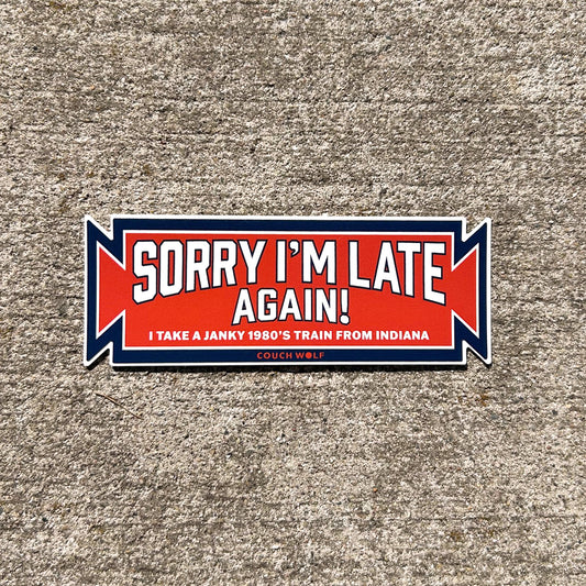 Sticker with text 'Sorry I'm late again! I take a janky 1980's train from Indiana' on a textured surface.